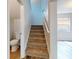 Staircase with carpet runner and half bath at 107 Littleton Cir, Deland, FL 32724