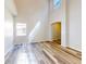 Bright living room with high ceilings, large windows, and light wood-look flooring at 107 Littleton Cir, Deland, FL 32724