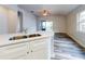 Modern kitchen with white cabinets, stainless steel appliances, and quartz countertops at 107 Littleton Cir, Deland, FL 32724