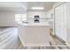 Modern kitchen with white cabinets, island, and stainless steel appliances at 107 Littleton Cir, Deland, FL 32724