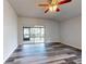 Bright living room with vinyl plank flooring and sliding glass doors to patio at 107 Littleton Cir, Deland, FL 32724