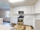 Modern kitchen with white cabinets and stainless steel appliances at 107 Littleton Cir, Deland, FL 32724