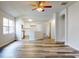 Open concept living room with kitchen view and hardwood floors at 107 Littleton Cir, Deland, FL 32724