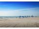 Beachfront view with blue umbrellas and lounge chairs at 814 Canyon Creek Dr, New Smyrna Beach, FL 32168