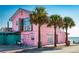 Pink beachfront restaurant building with palm trees and ocean view at 814 Canyon Creek Dr, New Smyrna Beach, FL 32168