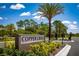 Copper Creek community entrance with signage, lush landscaping, and gated access at 814 Canyon Creek Dr, New Smyrna Beach, FL 32168