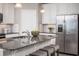 Modern kitchen island with granite countertops and stainless steel appliances at 814 Canyon Creek Dr, New Smyrna Beach, FL 32168