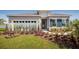 Two-story home with gray exterior, landscaped yard, and two-car garage at 1897 Basenji Dr, Lake Alfred, FL 33850