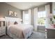 Light and airy bedroom with pink bedding at 1897 Basenji Dr, Lake Alfred, FL 33850