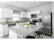 Modern kitchen with white cabinets, granite countertops, and stainless steel appliances at 1641 Laia Rd, Haines City, FL 33844