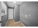 Bright laundry room with white door and wood-look flooring at 77 Redwood Rd, Ocala, FL 34472