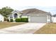 Gray house exterior, two-car garage, and concrete driveway at 90 Dogwood Drive Cir, Ocala, FL 34472