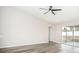 Living area with vinyl flooring, sliding doors to patio, and ceiling fan at 90 Dogwood Drive Cir, Ocala, FL 34472