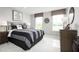 Bright bedroom with striped bedding and plenty of natural light at 1299 Whispering Ln, Minneola, FL 34715