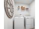 Convenient laundry room with washer, dryer, and overhead shelving at 1299 Whispering Ln, Minneola, FL 34715