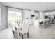 Modern kitchen with white cabinets, island, and dining area at 1299 Whispering Ln, Minneola, FL 34715