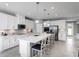 Modern kitchen with white cabinets, large island, and stainless steel appliances at 1299 Whispering Ln, Minneola, FL 34715