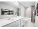 Clean bathroom with double vanity, bathtub, and shower at 1299 Whispering Ln, Minneola, FL 34715