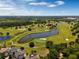 Aerial view of a lush golf course with lakes and fairways at 6923 Five Oaks Dr, St Cloud, FL 34773
