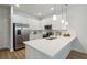 Modern white kitchen with stainless steel appliances and an island at 6923 Five Oaks Dr, St Cloud, FL 34773