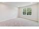 Bright and airy bedroom with carpeted floors and a large window at 6923 Five Oaks Dr, St Cloud, FL 34773