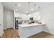 Modern white kitchen with stainless steel appliances and an island at 6923 Five Oaks Dr, St Cloud, FL 34773