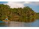 Person kayaking on a calm lake with lush trees in the background at 6923 Five Oaks Dr, St Cloud, FL 34773