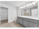 Double vanity bathroom with gray cabinets and a toilet at 6923 Five Oaks Dr, St Cloud, FL 34773