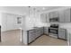 Modern gray kitchen with stainless steel appliances and an island at 6923 Five Oaks Dr, St Cloud, FL 34773