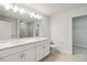 Double vanity bathroom with white cabinets and a walk-in shower at 6923 Five Oaks Dr, St Cloud, FL 34773