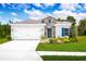 One-story home with white siding, stone accents, and blue shutters at 1337 Laramie Way, Haines City, FL 33844