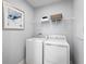 Bright laundry room, washer, dryer, and shelving at 1337 Laramie Way, Haines City, FL 33844
