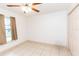 Bedroom with tiled floors, window, ceiling fan, and double-door closet at 6000 Marthas Ln, Saint Cloud, FL 34771