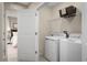 Convenient laundry room with washer, dryer, and shelving at 1602 Minnesota Rd, Sumterville, FL 33585