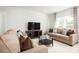 Open-concept living space with neutral decor and cozy seating at 1602 Minnesota Rd, Sumterville, FL 33585