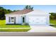 Single-story home with two-car garage and attractive landscaping at 1602 Minnesota Rd, Sumterville, FL 33585