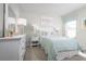 Charming bedroom with a light teal comforter and white dresser at 1602 Minnesota Rd, Sumterville, FL 33585
