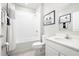 Clean bathroom features a tub shower combo and white vanity at 1602 Minnesota Rd, Sumterville, FL 33585