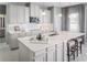 Open kitchen with white cabinets, large island, and stainless steel appliances at 5745 Anders Way, St Cloud, FL 34771