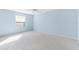 Spacious bedroom with light blue walls and carpet at 1052 Ridgeville Rd, The Villages, FL 32162