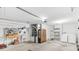Garage with washer, dryer, workbench, and storage shelves at 1052 Ridgeville Rd, The Villages, FL 32162
