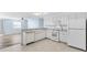 Modern kitchen with white cabinets, gas range and dishwasher at 1052 Ridgeville Rd, The Villages, FL 32162