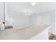 White kitchen features a breakfast bar and modern appliances at 1052 Ridgeville Rd, The Villages, FL 32162