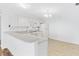 Kitchen with white cabinets, granite countertops, and breakfast bar at 1052 Ridgeville Rd, The Villages, FL 32162