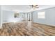 Living room with hardwood floors, ceiling fan, and access to the backyard at 1052 Ridgeville Rd, The Villages, FL 32162