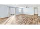 Spacious living area with hardwood floors, light walls, and sliding glass doors at 1052 Ridgeville Rd, The Villages, FL 32162