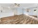 Open concept living room and kitchen with hardwood floors and light walls at 1052 Ridgeville Rd, The Villages, FL 32162