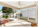 Spacious screened porch with ceiling fan, providing an outdoor living space at 1052 Ridgeville Rd, The Villages, FL 32162