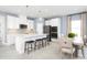 Open concept kitchen with white cabinets, stainless steel appliances, and an island with seating at 5094 Grand Teton Ct, Deland, FL 32724