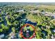 Wide aerial shot showing a house and surrounding landscape near a lake at 104 Sunset Way, Fruitland Park, FL 34731